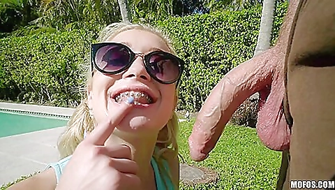 Blonde babe with big smile in red bra taking a facial