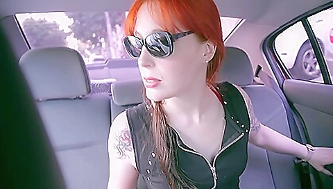 A tattooed redhead is having a threesome with a brunette