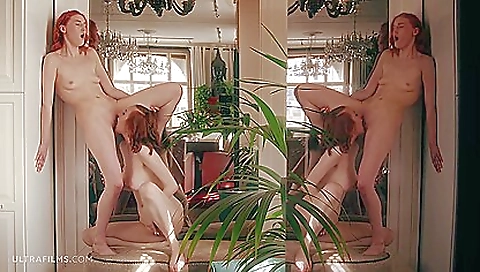 Stunning redhead with red hair and a sexy dress is playing